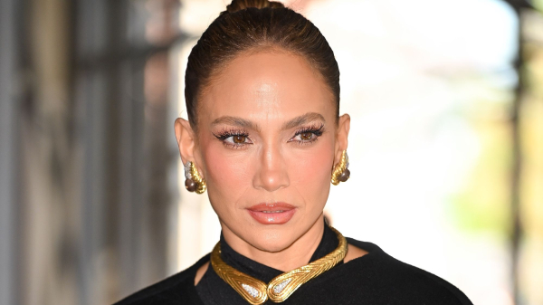 Jennifer Lopez wearing a black coat and gold jewelry