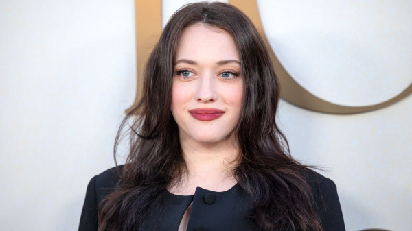 Kat Dennings poses in a black jacket